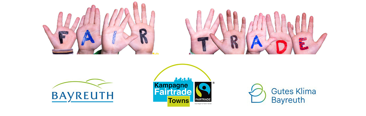 Kinderhände auf denen Fair Trade steht und drei Logos