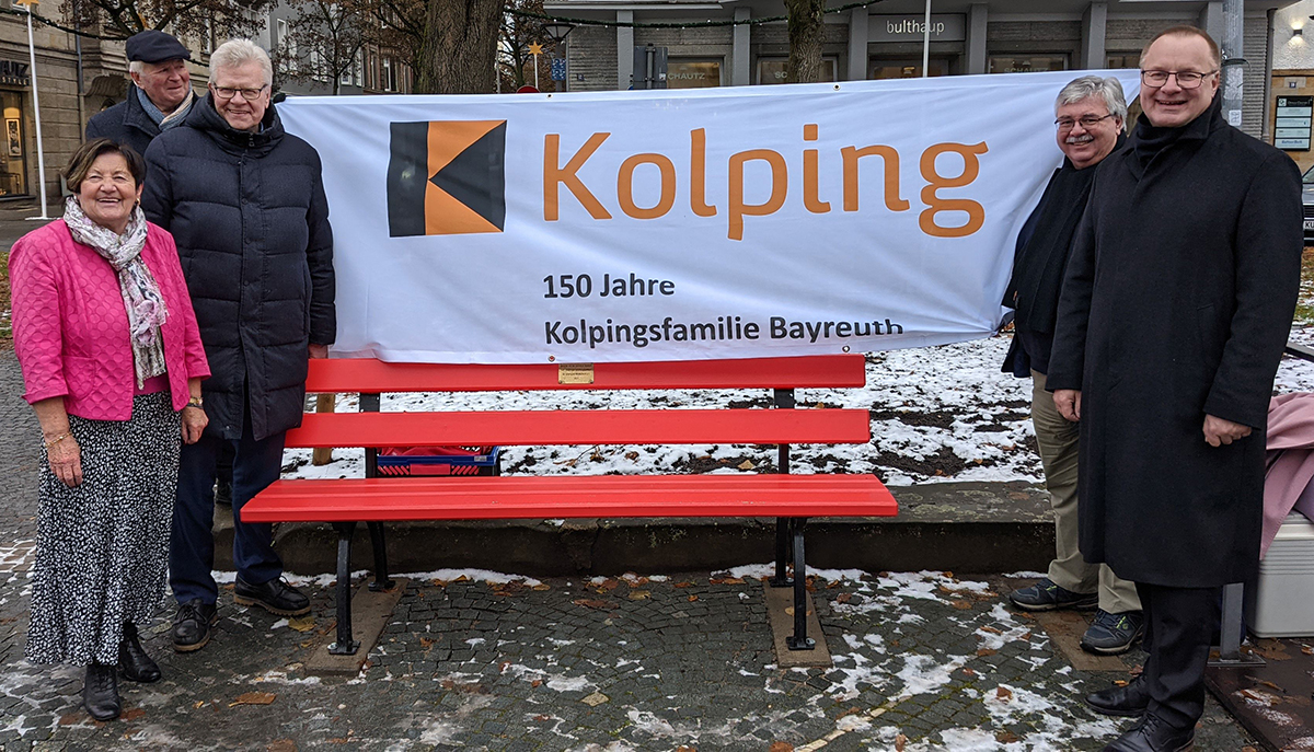 Wolfram Münch, Vorstandsvorsitzender der Sparkasse Bayreuth, Stadtgartenamtsleiter Robert Pfeifer, Oberbürgermeister Thomas Ebersberger, und Maria Anna Link, Vorstand der Kolpingsfamilie Bayreuth (von rechts), mit ihrem Ehemann Manfred stehen um die rote Bank herum.