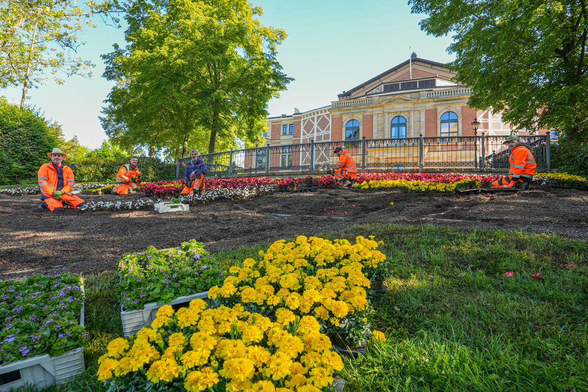 Gärtnerinnen und Gärtner des Stadtgartenamtes der Stadt Bayreuth pflanzen vor dem Festspielhaus das "W". Foto: Stadt Bayreuth